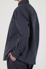back view of casey casey drays shirt blu skull  its dropped shoulders offer a loose, flowing shape that suits both layered looks and standalone wear.