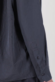 detail view of casey casey drays shirt blu skull buttons at the cuffs, tapered sleeve towards the cuffs