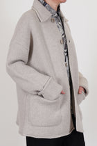 side view of casey casey jacket rove light grey wool relaxed knitted style with drop shoulders, loose fit and big patch pockets. 