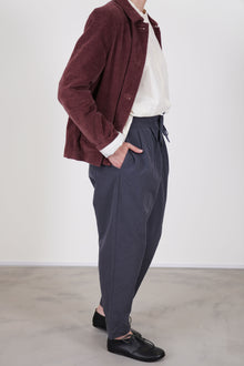 side view of casey casey tippy pant blu skull worn with pwet jacket velvet prune