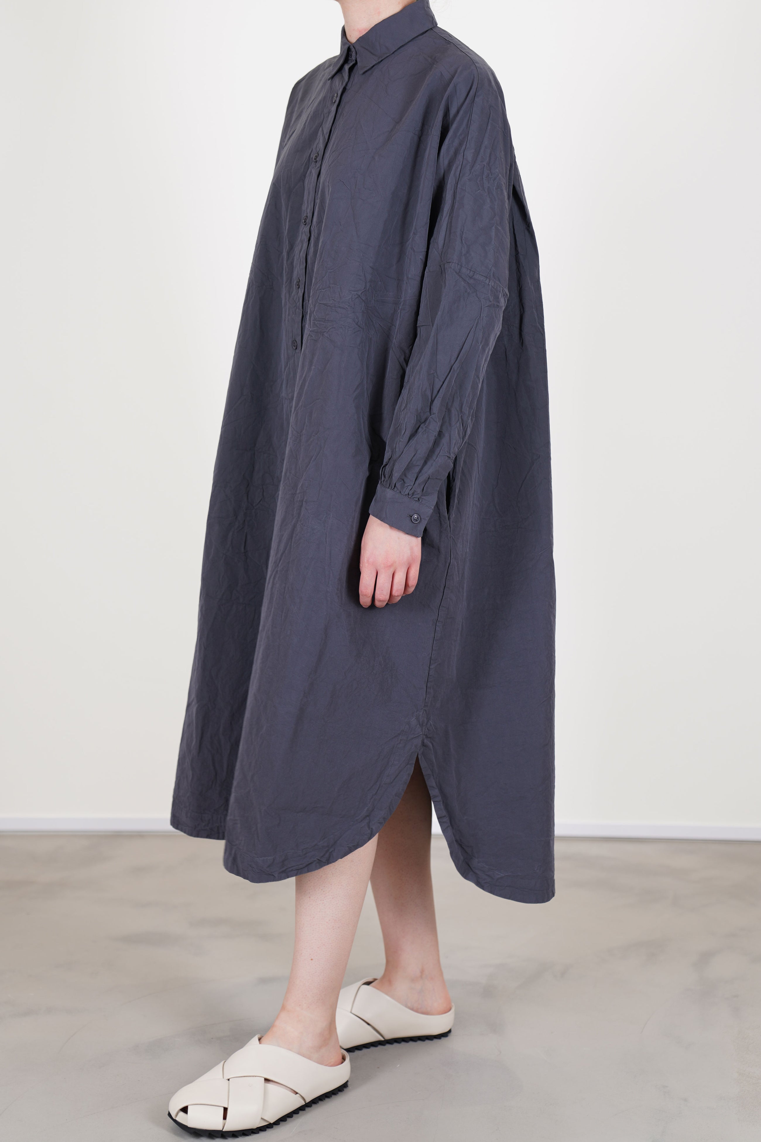 side view of casey casey yuki dress blu skull shirt dress style curved hemline, drop shoulders, slimmer fitted sleeves with gathered details at the cuffs.