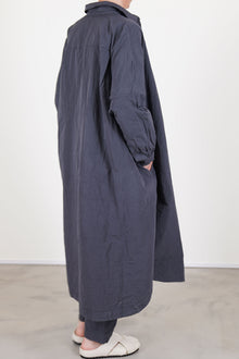 back view of casey casey yuki dress blu skull worn as an overcoat, side pocket details and paired with matching tippy pants