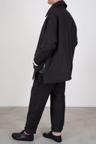 side view of casey casey sunny bab jacket dark brown oversized and loose fit, straight hemline with side slit details. 