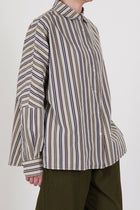 side view of casey casey waga shirt as is n°4 featuring a washed finish, dolman sleeves that are tapered towards the cuffs and a slightly curved hemline. 