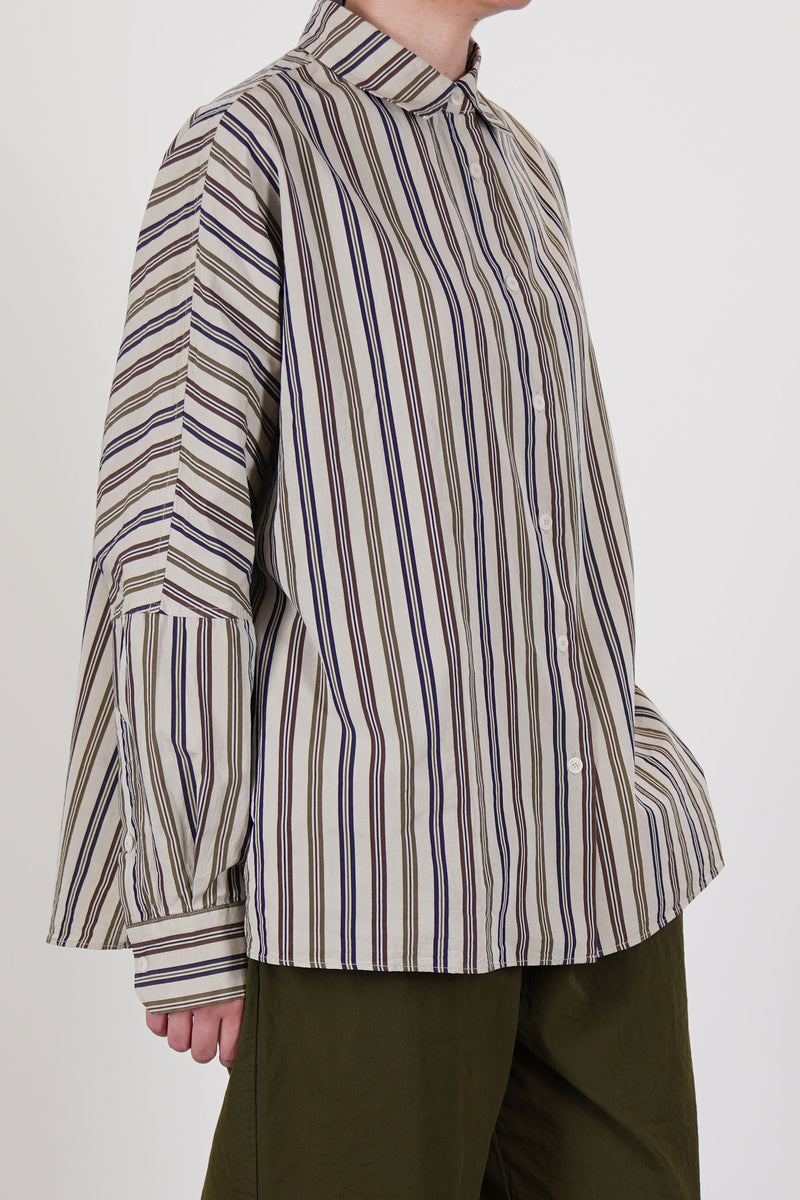 side view of casey casey waga shirt as is n°4 featuring a washed finish, dolman sleeves that are tapered towards the cuffs and a slightly curved hemline. 