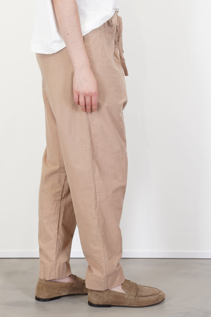 profile view of casey casey tied sarouel pant cotton beige tapered leg and effortless look