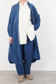 model wears casey casey yuki dress tuareg blue as an overcoat in a modern look