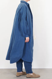 side view of casey casey yuki dress tuareg blue worn with trousers
