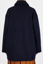 back view of école de curiosités claus coat loden wool dark navy shorter length and relaxed and loose fit