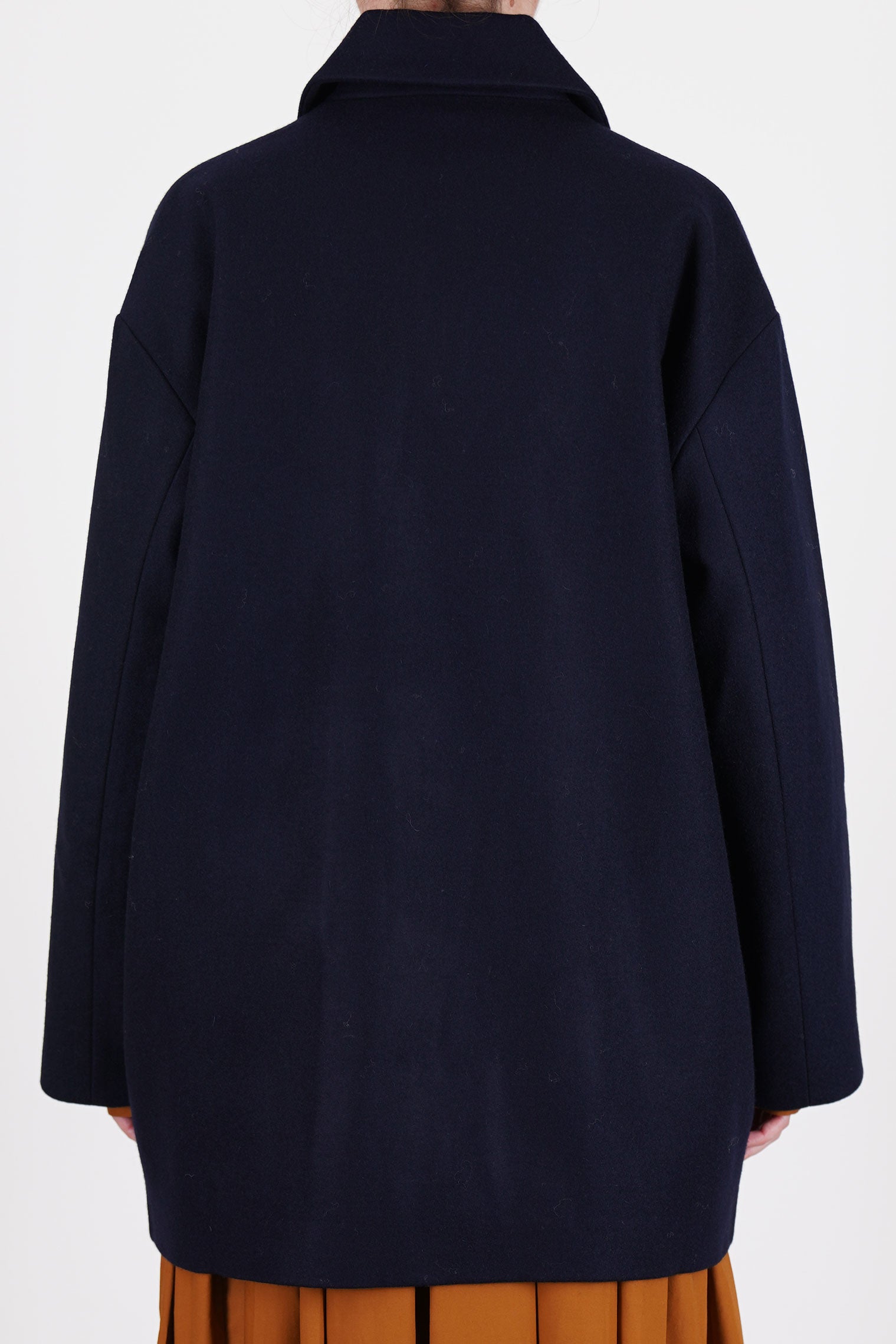 back view of école de curiosités claus coat loden wool dark navy shorter length and relaxed and loose fit