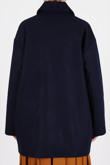 back view of école de curiosités claus coat loden wool dark navy shorter length and relaxed and loose fit