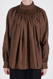 école de curiosités shirt anne cotton silk brown features a hand-smocked high neckline and a subtle button-down front