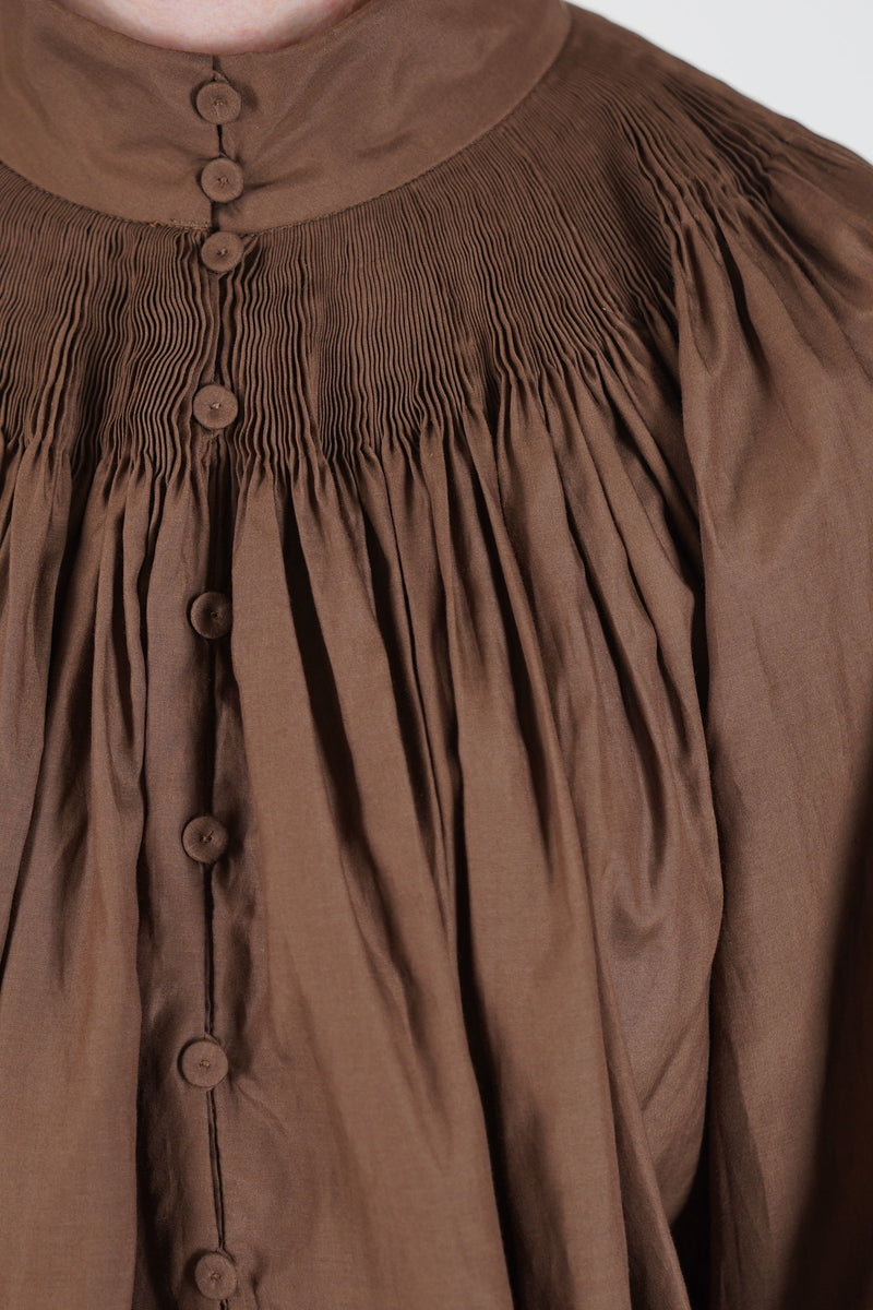 école de curiosités shirt anne cotton silk brown hand-smocked high neckline and a subtle covered button-down front.