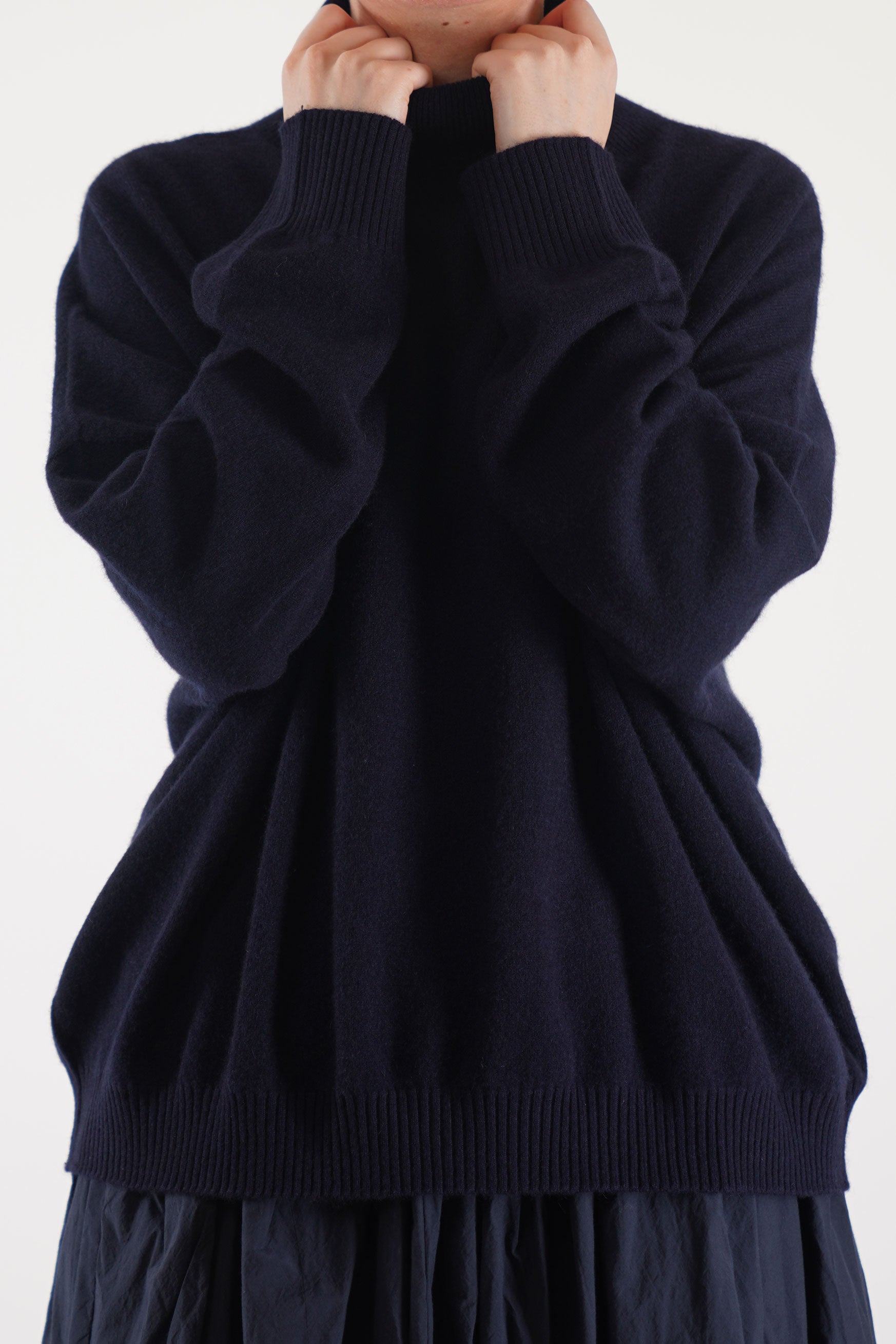 detail view of manuelle guibal zam cashmere turtleneck in nocturnewith cozy high neck and ribbed detailing
