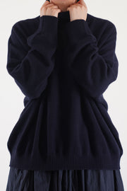 detail view of manuelle guibal zam cashmere turtleneck in nocturnewith cozy high neck and ribbed detailing