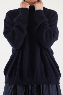 detail view of manuelle guibal zam cashmere turtleneck in nocturnewith cozy high neck and ribbed detailing