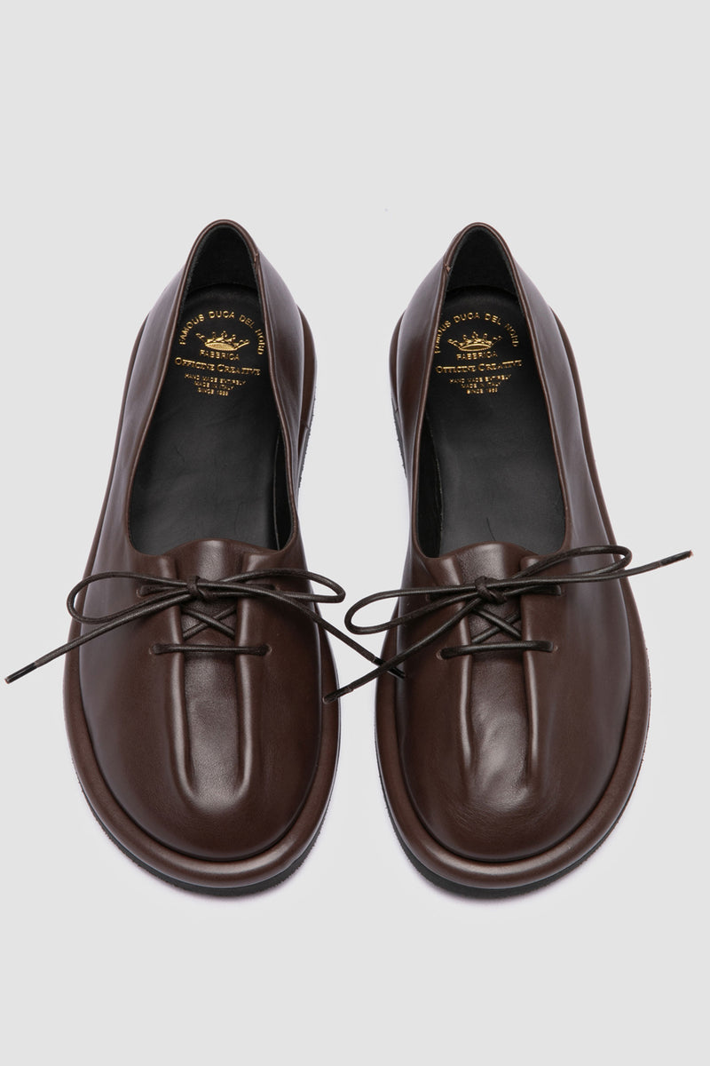 Handmade Italian flats in rich brown leather by Officine Creative, designed with front adjustable laces 