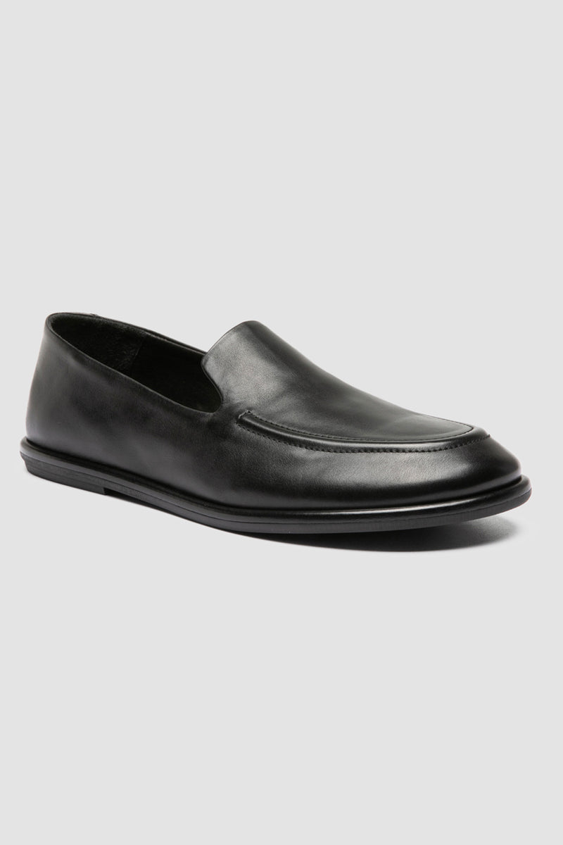 Close-up of Officine Creative Mienne 101 loafers in soft black leather, showcasing fine Italian craftsmanship and minimalist rubber sole design.