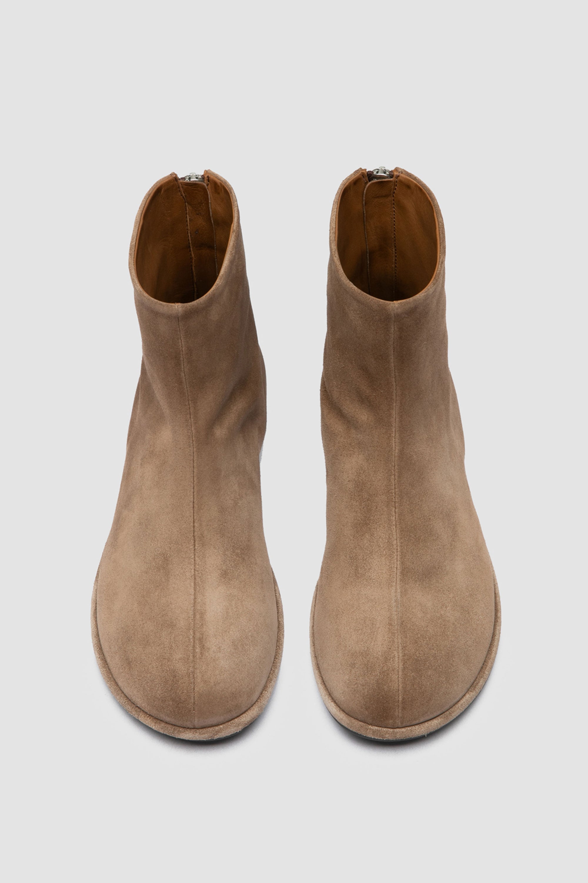 Close-up of Officine Creative suede boots showing handcrafted Italian construction, soft suede texture