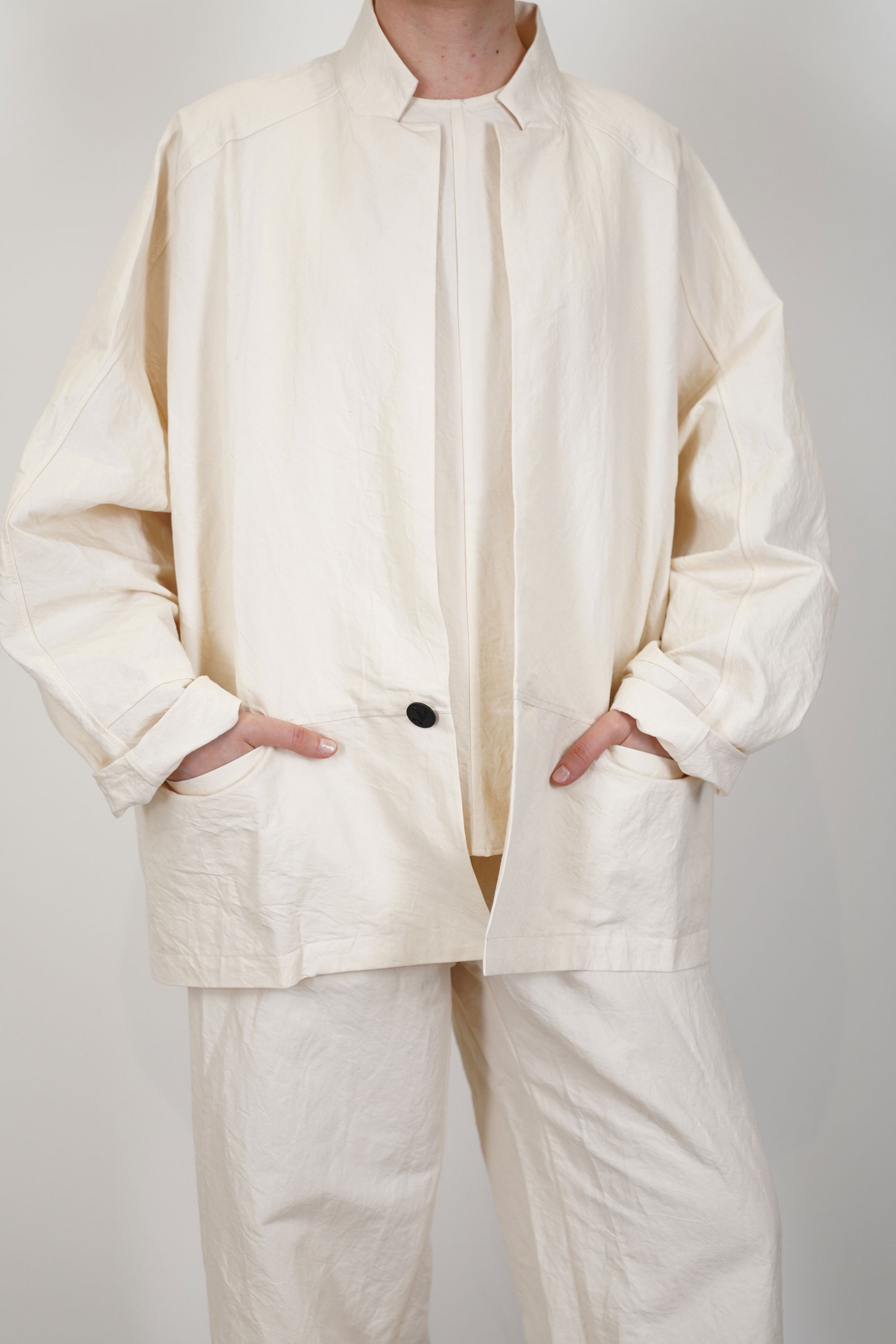 front detail view of oyuna absent paper jacket ivory