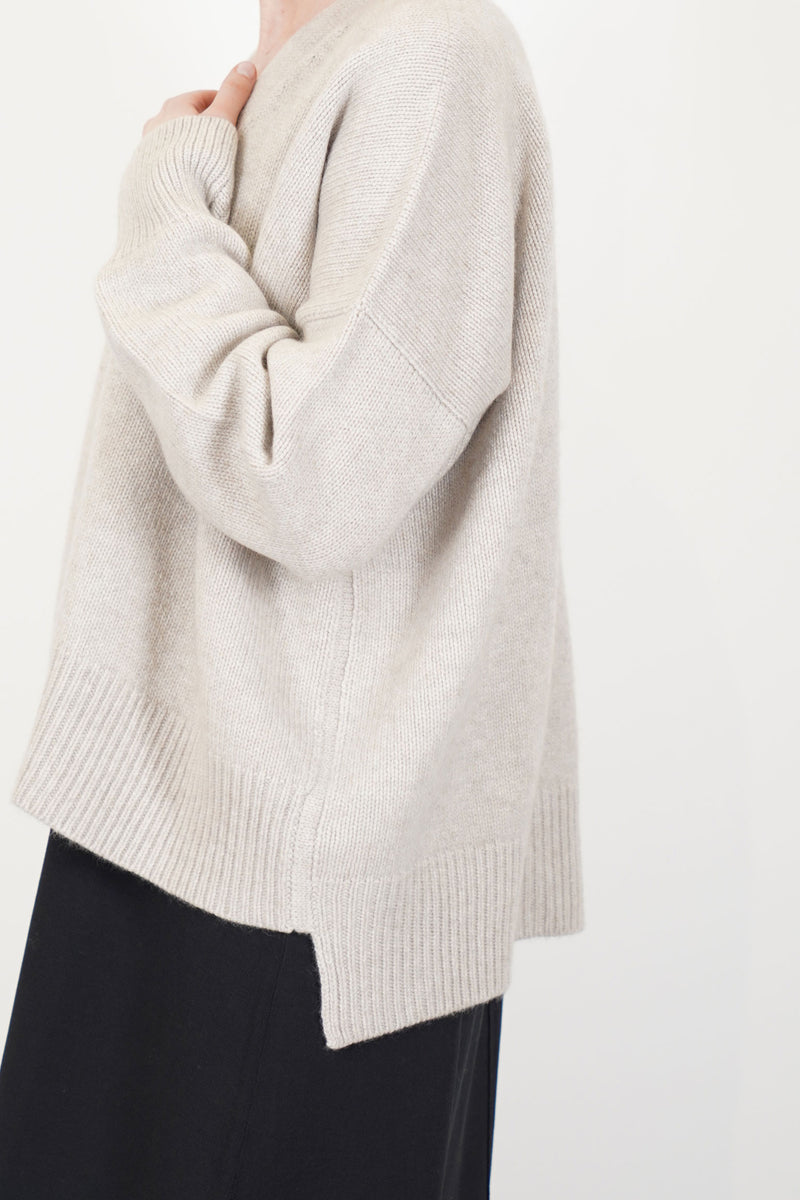 close up of oyuna aire knit cardigan cashmere feather drop shoulders and luxurious heavy knit