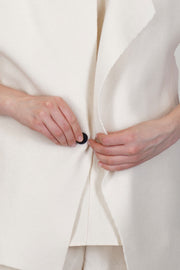 close up view of oyuna moon jacket cashmere ivory front button detail