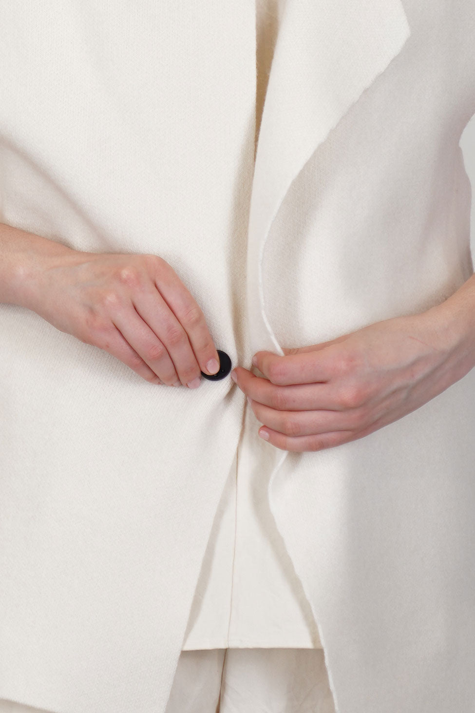 close up view of oyuna moon jacket cashmere ivory front button detail