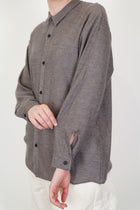 close up of oyuna omou knitted shirt moccha button detail at the cuffs