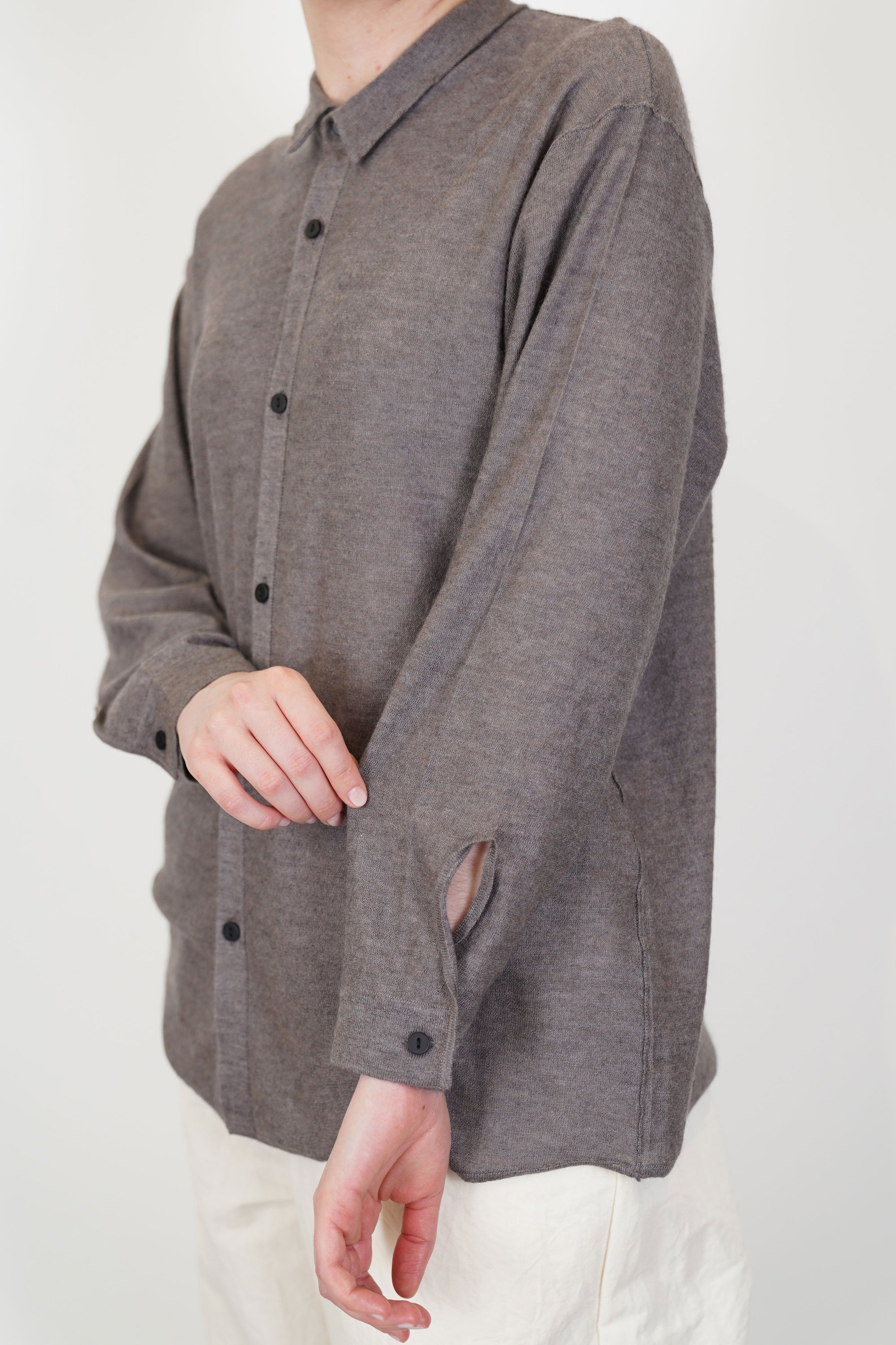 close up of oyuna omou knitted shirt moccha button detail at the cuffs