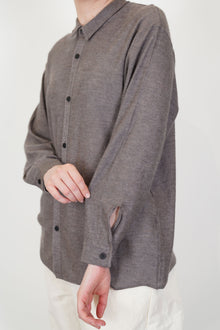 close up of oyuna omou knitted shirt moccha button detail at the cuffs
