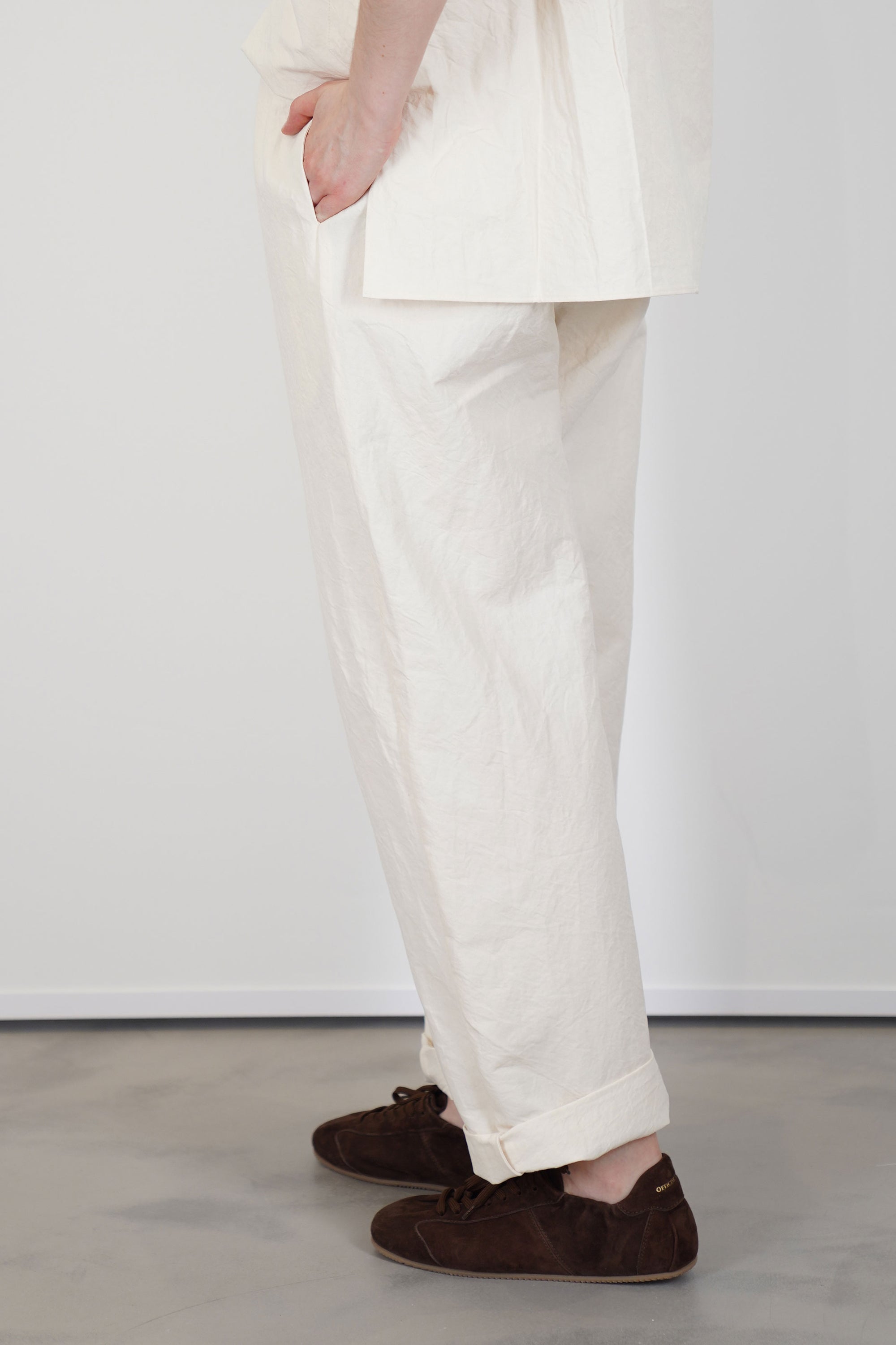 profile view of passage paper trousers ivory  tapered leg
