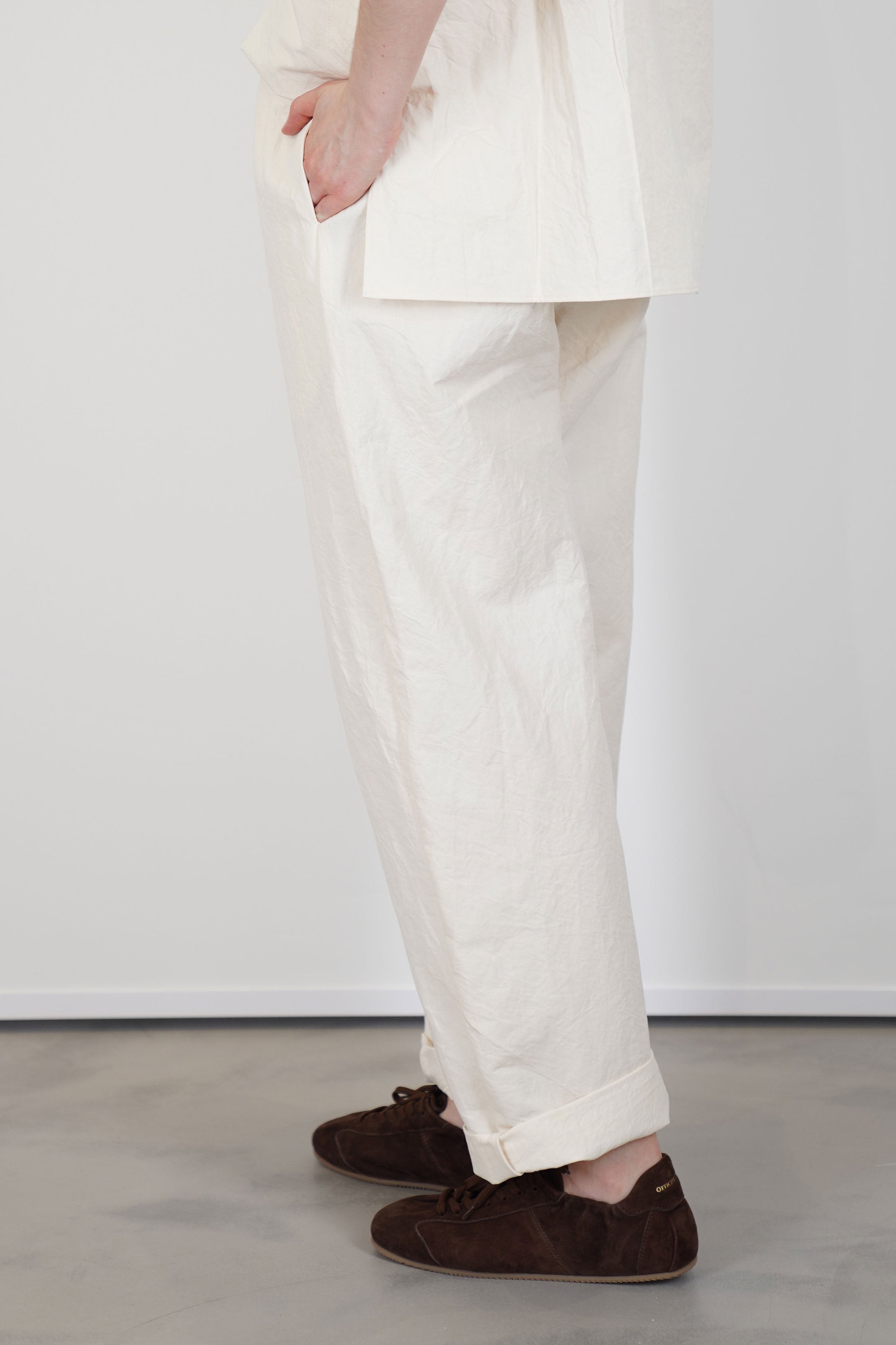 profile view of passage paper trousers ivory  tapered leg