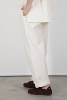 profile view of passage paper trousers ivory  tapered leg