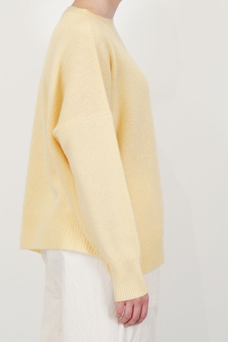 profile view of oyuna shiru cashmere sweater whisper drop shoulders and long sleeves