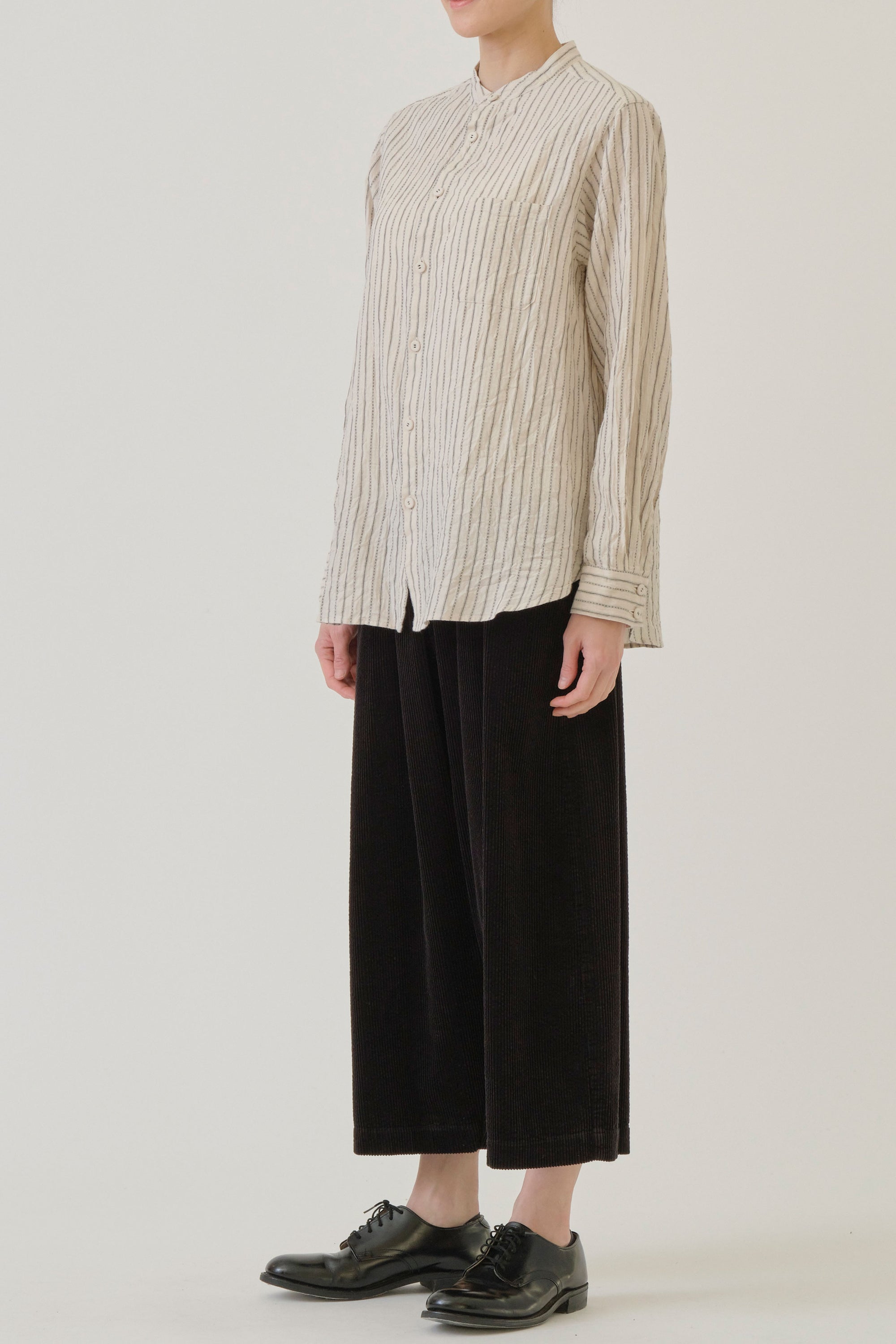 side view of pas de calais dobby stripe shirring brushed blouse ivory chest pocket detail, button front opening and a relaxed and loose cut. 