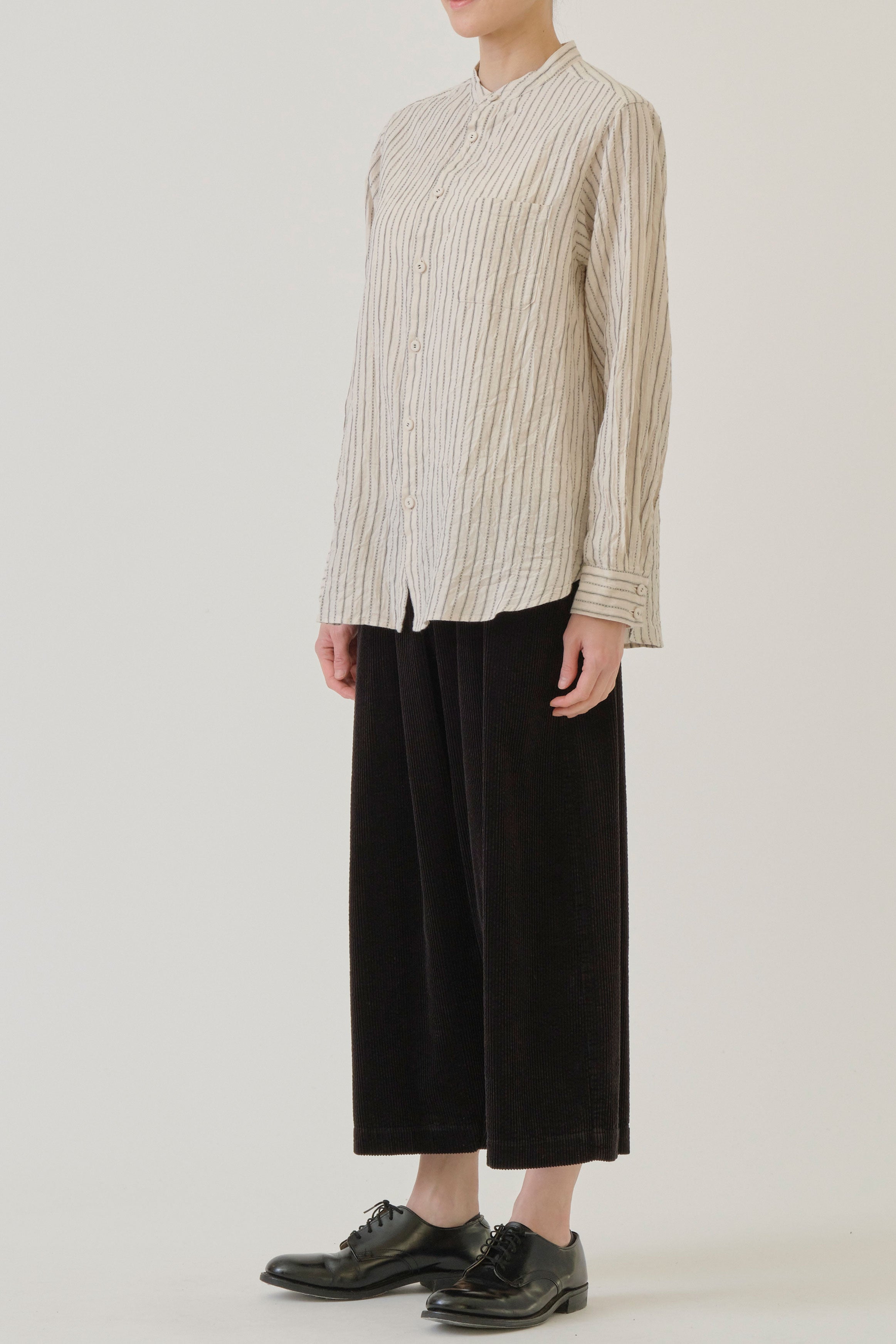 side view of pas de calais dobby stripe shirring brushed blouse ivory chest pocket detail, button front opening and a relaxed and loose cut. 