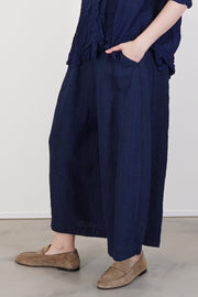profile view of pas de calais chambray wide pants linen indigo cropped length and practical side pocket detail