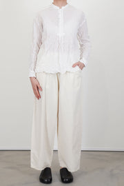 model wearing pas de calais crinkle stand collar shirt white