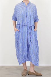 model wearing pas de calais shirring stripe dress saxe blue effortless style, additional belt detail for a diversity of styling