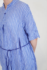 close up of pas de calais shirring stripe dress saxe blue crinkled soft cotton material and thin stripe detail