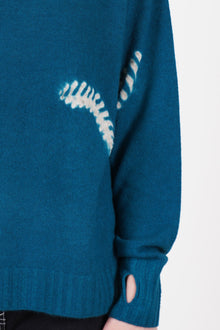 detail view of suzusan cashmere seamless turtleneck pull dark teal sand raglan sleeves with thumb hole detail at the cuffs and a ribbed details.