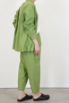profile view of toogood acrobat trousers poplin grass slightly cropped length and tapered leg