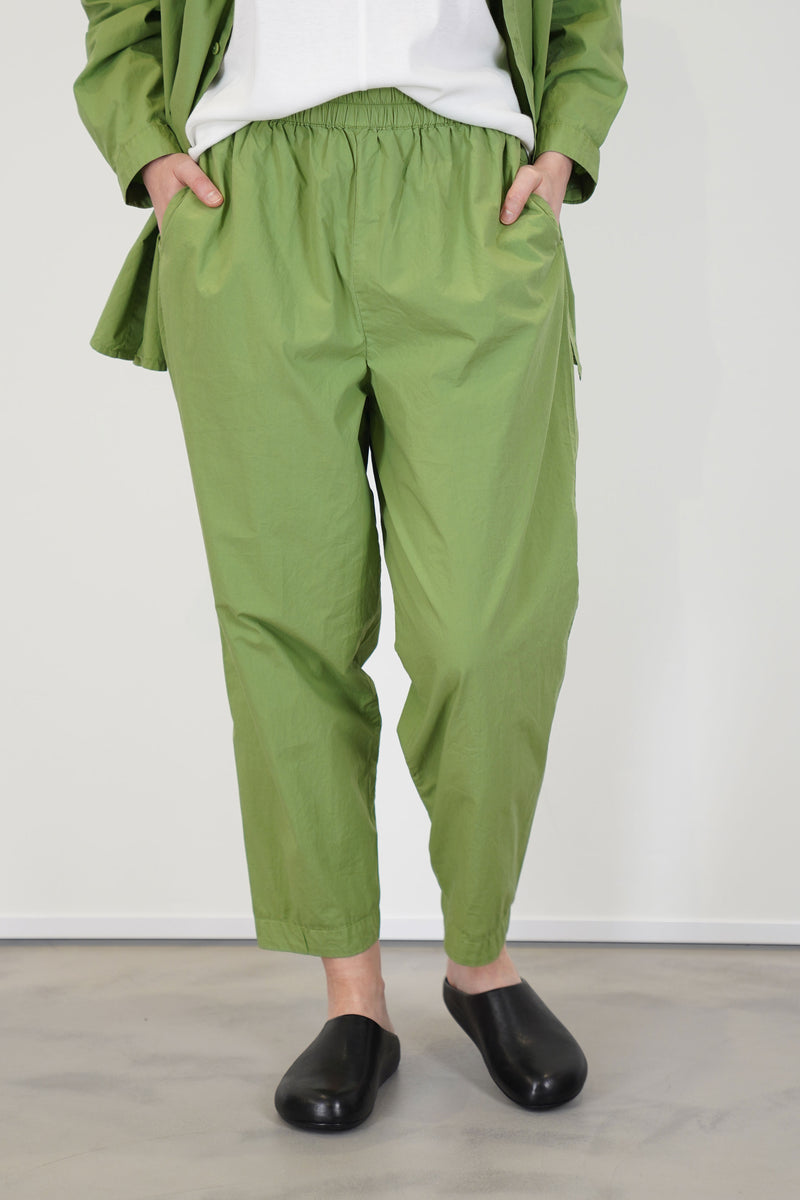 front view of toogood acrobat trousers poplin grass  lightweight material and relaxed silhouette