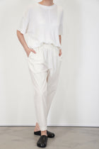 front view of toogood acrobat trousers poplin yoghurt loose and relaxed fit, accompanied by tapered legs and an elasticated waistband