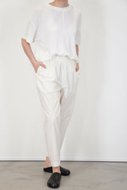 front view of toogood acrobat trousers poplin yoghurt loose and relaxed fit, accompanied by tapered legs and an elasticated waistband