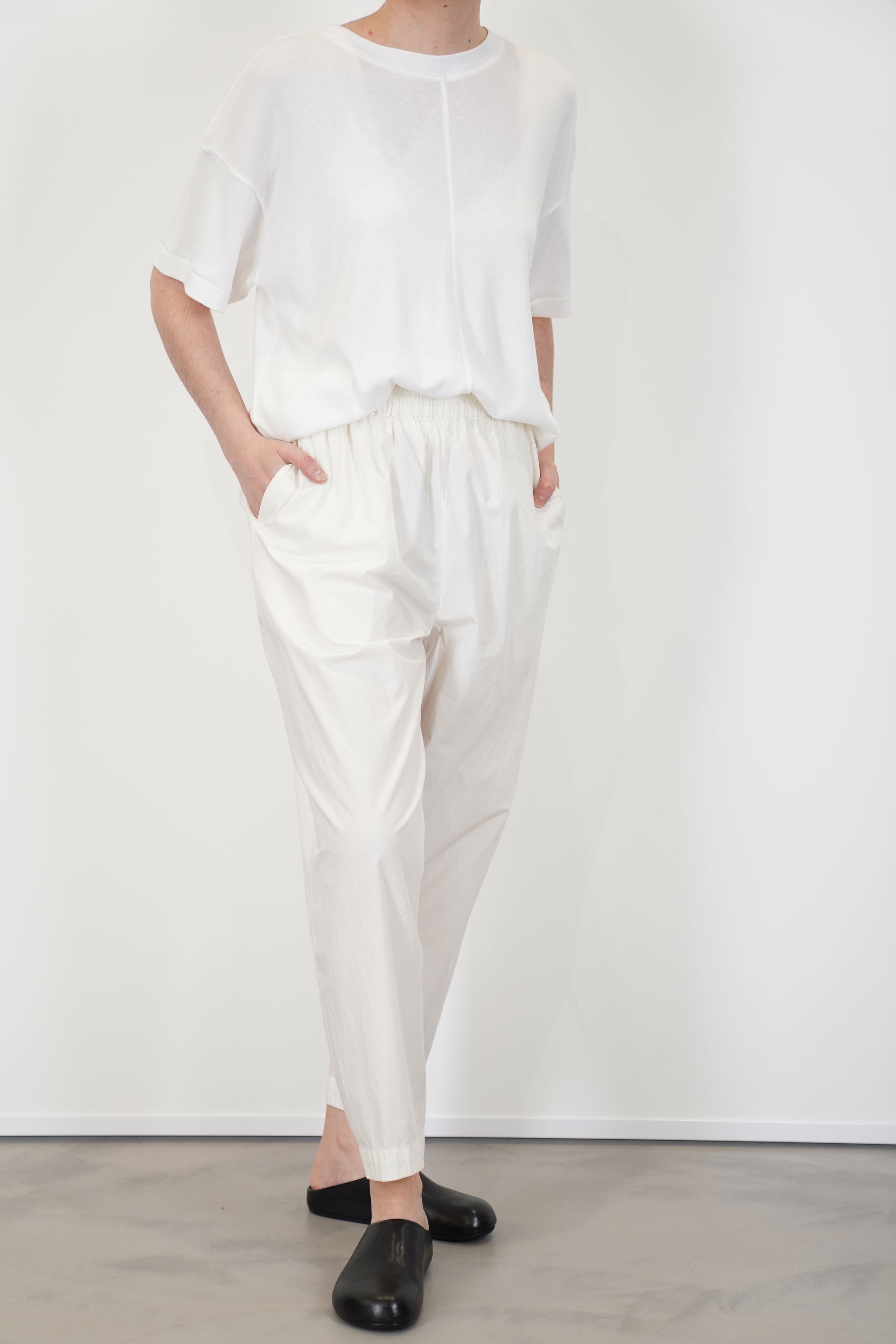 front view of toogood acrobat trousers poplin yoghurt loose and relaxed fit, accompanied by tapered legs and an elasticated waistband