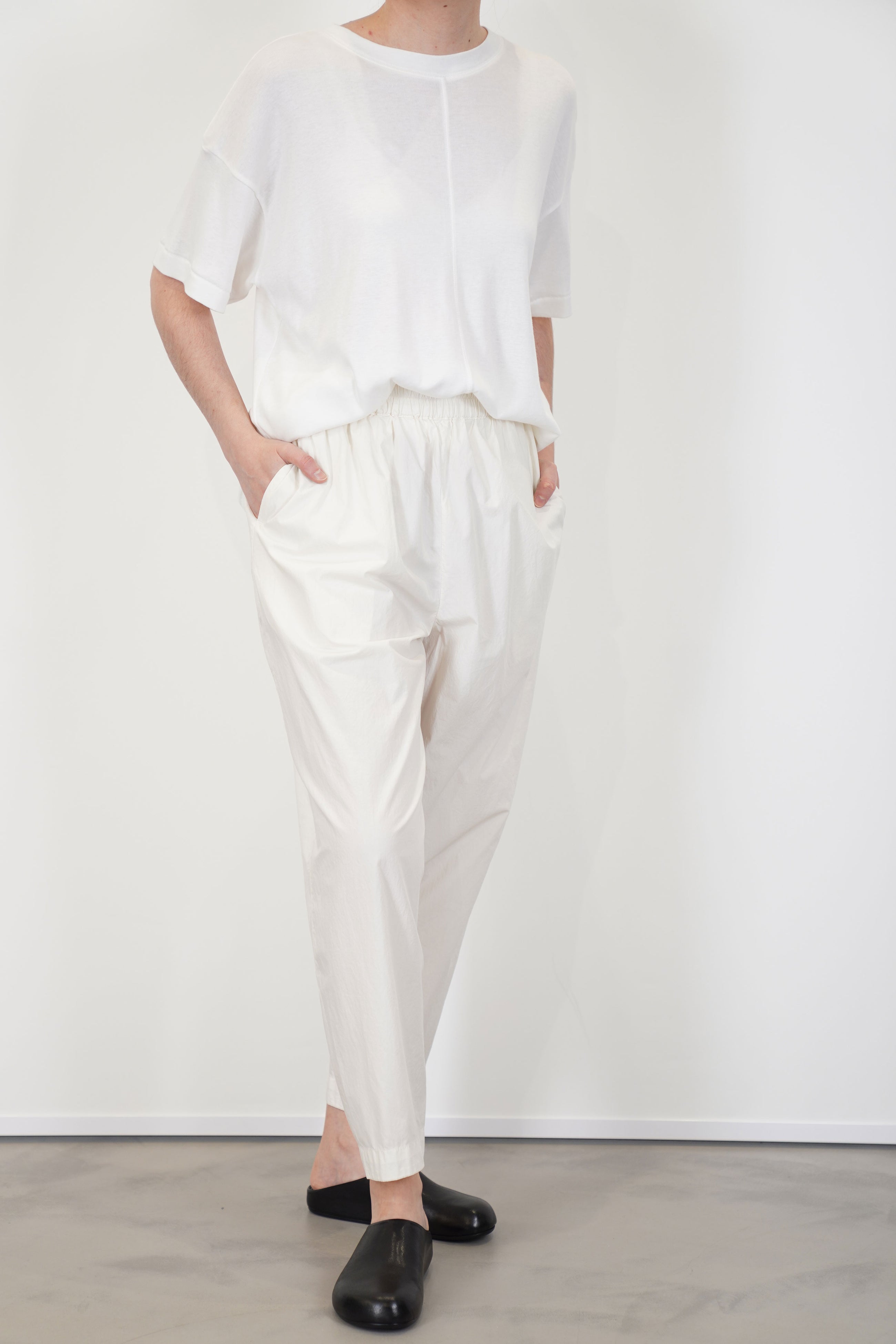 front view of toogood acrobat trousers poplin yoghurt loose and relaxed fit, accompanied by tapered legs and an elasticated waistband